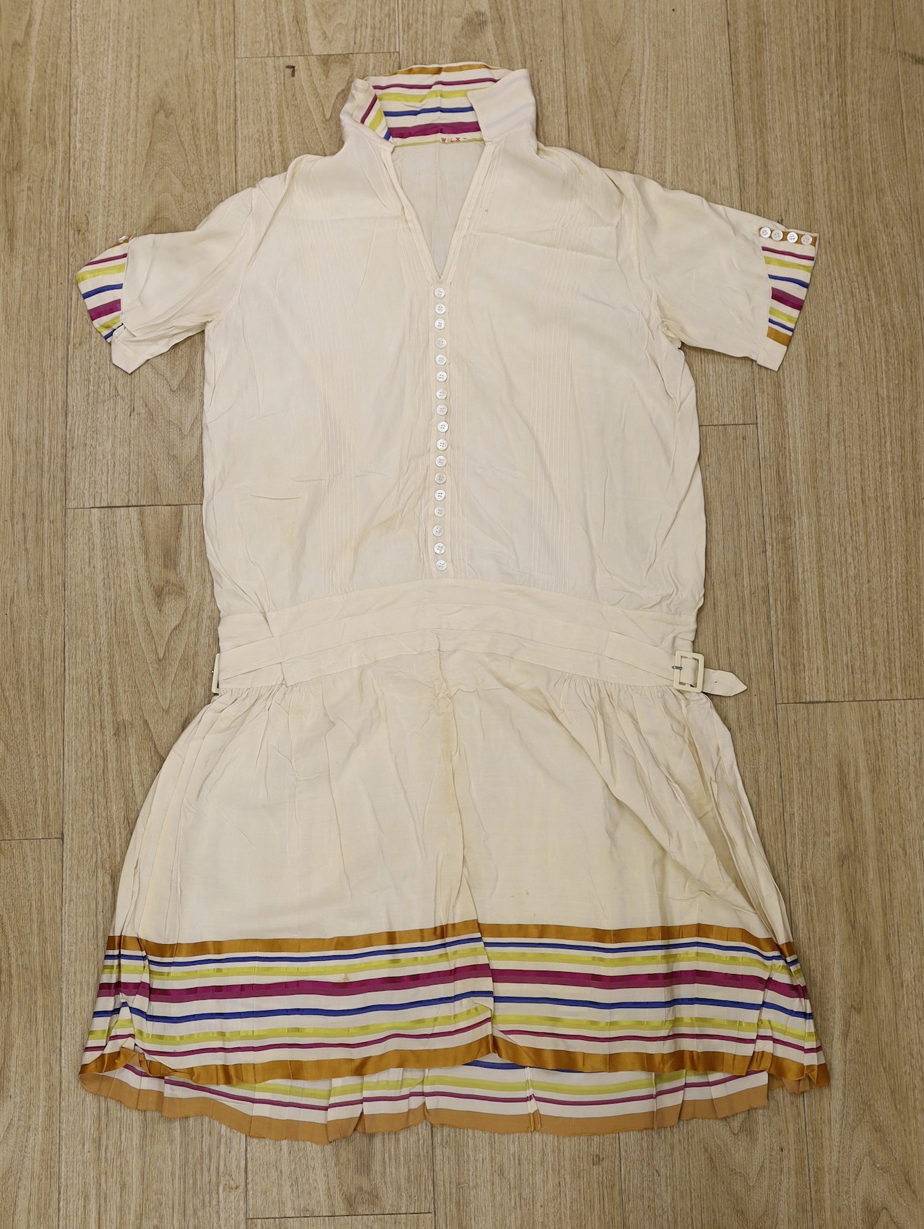 A 1920's cream silk tennis dress with multicoloured stripe collar, cuff and hem detail, together with a brown chiffon and gold lace 1920's evening dress